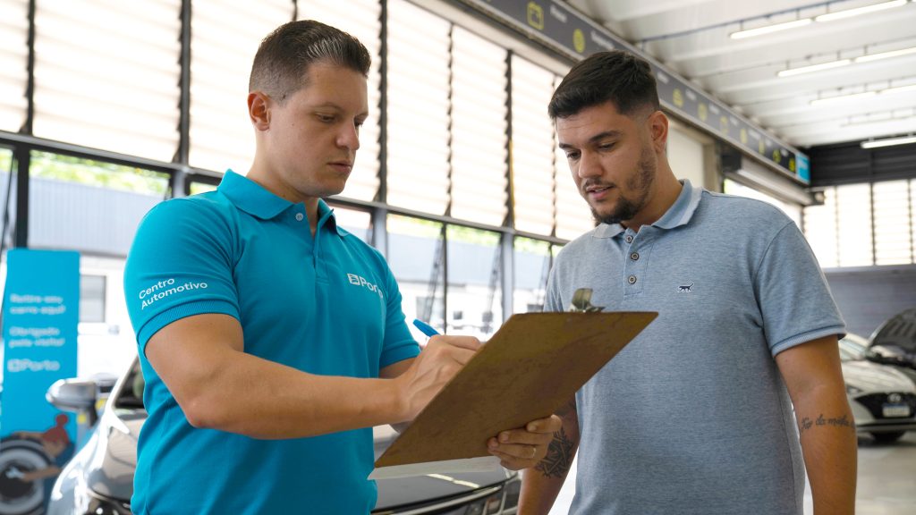 Cliente e prestador de serviço conversando sobre carro no Centro Automotivo Porto